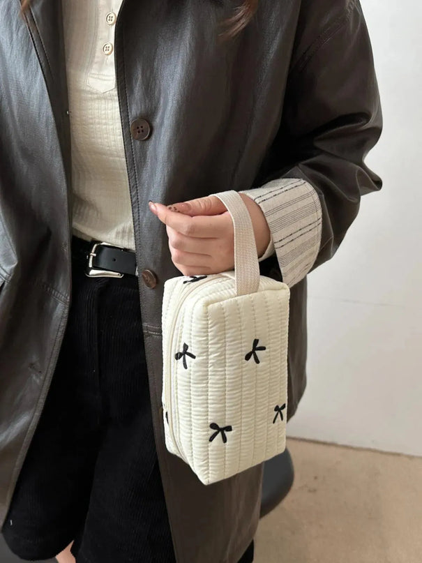 Minibolso de mano con detalle de lazo texturizado