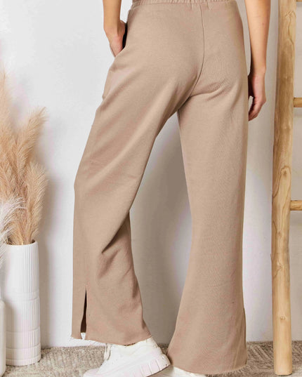 Pantalones elegantes de salón con pernera ancha, aberturas y cinturilla ancha